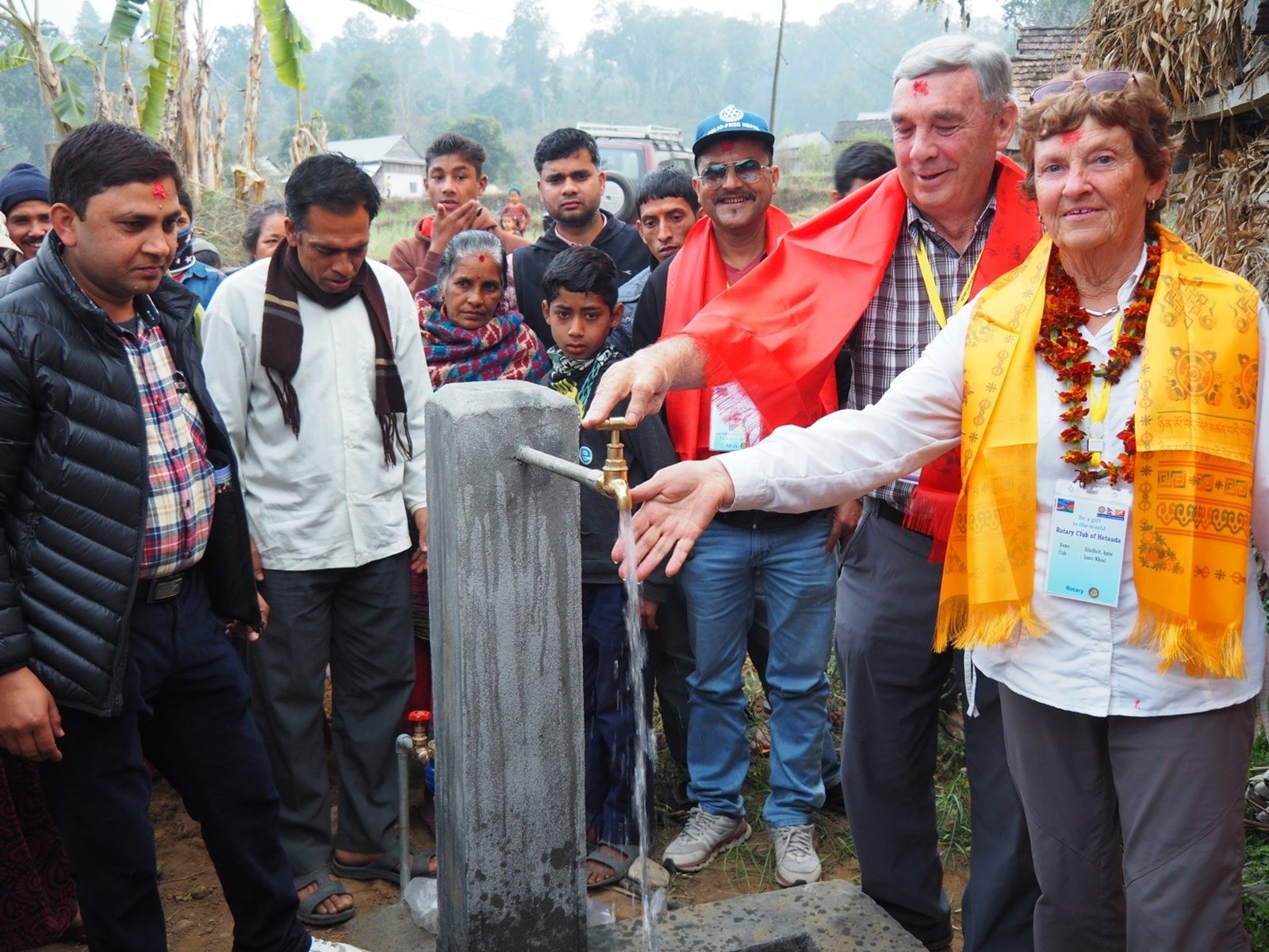Villagers and visiting Rotarians at the new water tap
